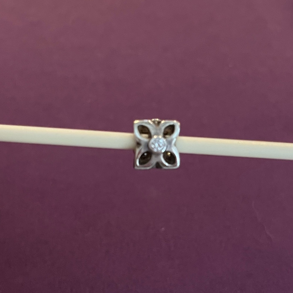 Pandora Retired Four Petal Flower Sterling silver and clear zirconia charm.
